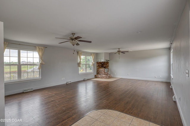 2502 S Tyler Ave, Joplin, MO 64804 - unfurnished living room featuring ceiling fan, wood-type flooring, and baseboards