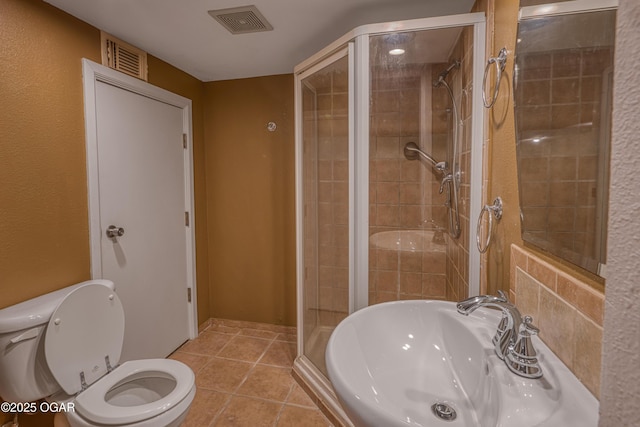 2502 S Tyler Ave, Joplin, MO 64804 - full bathroom with a sink, toilet, a stall shower, and tile patterned flooring