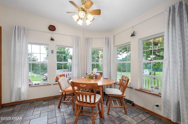 3759 Wheeler Branch Rd, Crane, MO 65633 - dining space featuring ceiling fan, baseboards, and stone finish floors