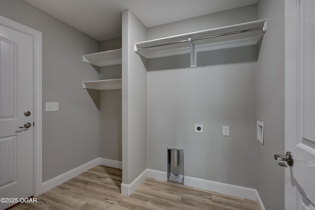 laundry area with electric dryer hookup, light wood-style flooring, and washer hookup
