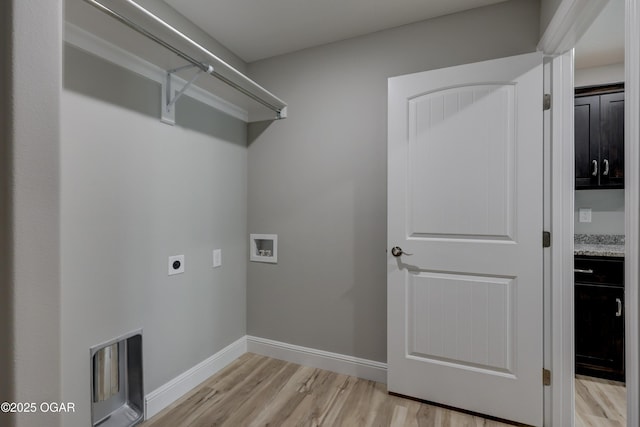 washroom featuring washer hookup, light wood finished floors, hookup for an electric dryer, and heating unit