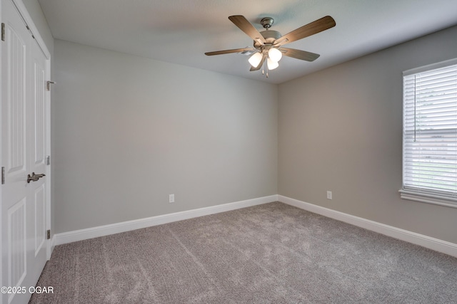 spare room featuring carpet flooring and a ceiling fan