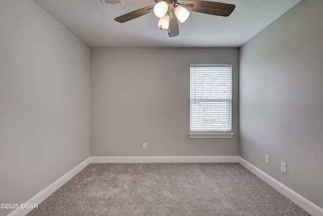 spare room with carpet and a ceiling fan
