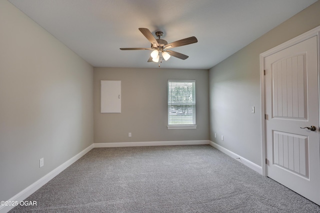 empty room with carpet floors and a ceiling fan