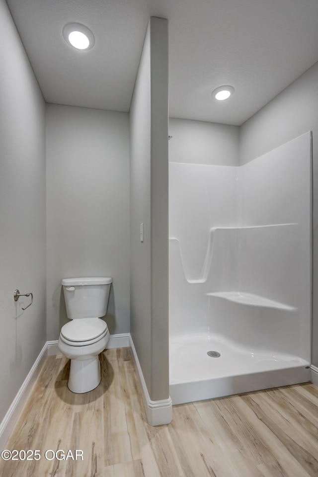 full bath with wood finished floors and a shower