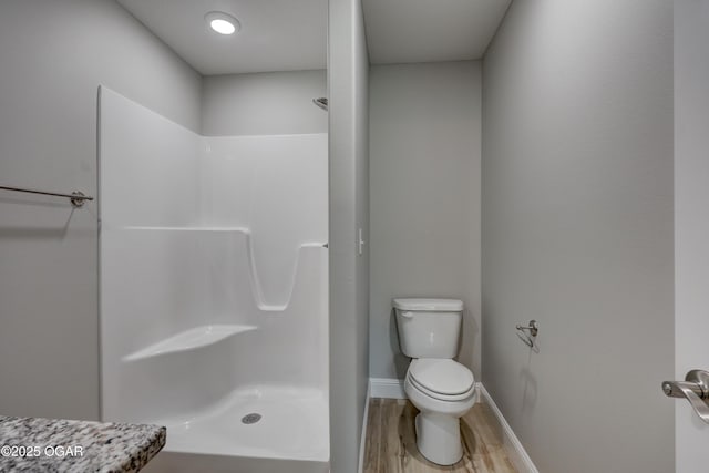 full bath with a shower and wood finished floors