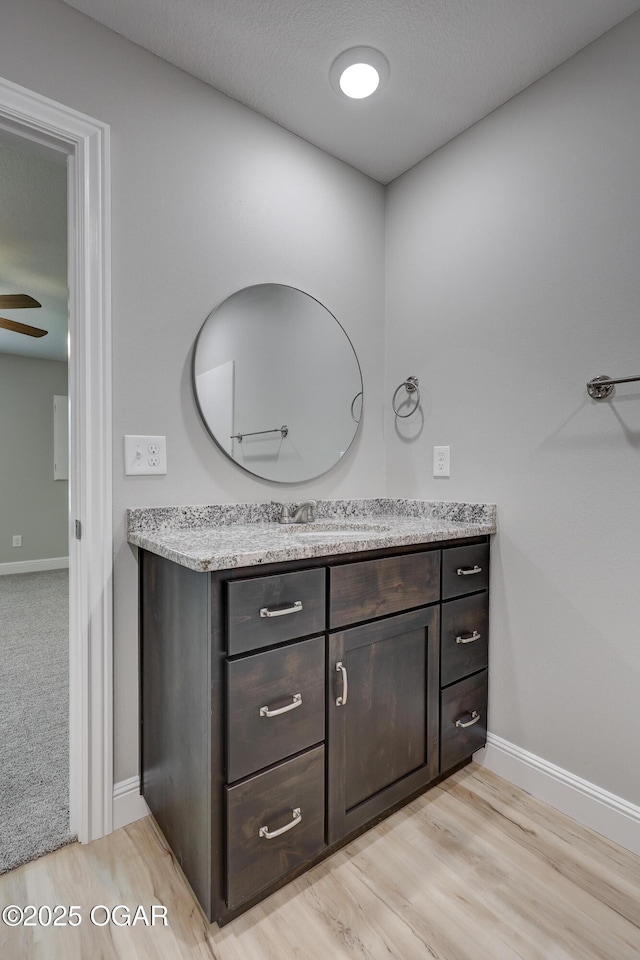 bathroom with vanity, wood finished floors, and a ceiling fan