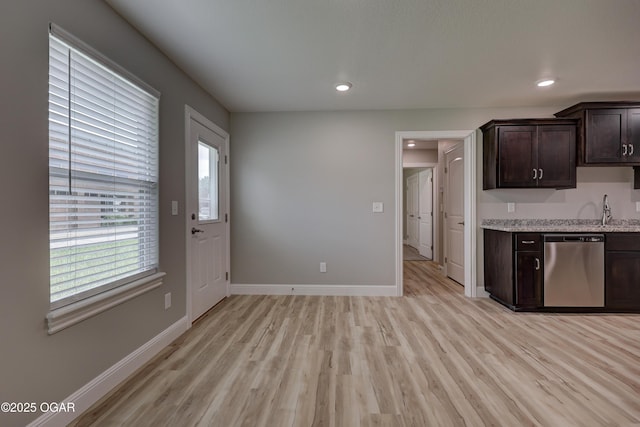 kitchen featuring dishwasher, dark brown cabinets, light wood finished floors, recessed lighting, and light stone countertops