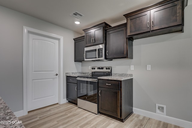 kitchen with stainless steel appliances, light wood-style flooring, dark brown cabinetry, recessed lighting, and light stone countertops