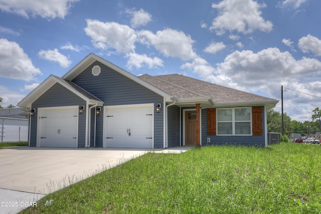 ranch-style house with a garage, concrete driveway, roof with shingles, and a front lawn