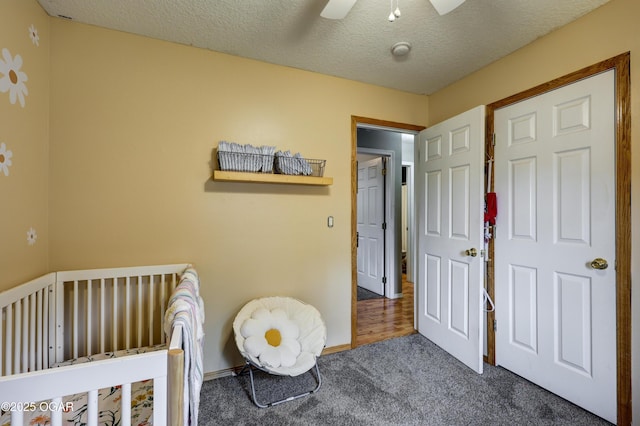 2413 Rolla St, Joplin, MO 64801 - carpeted bedroom with baseboards, ceiling fan, and a textured ceiling