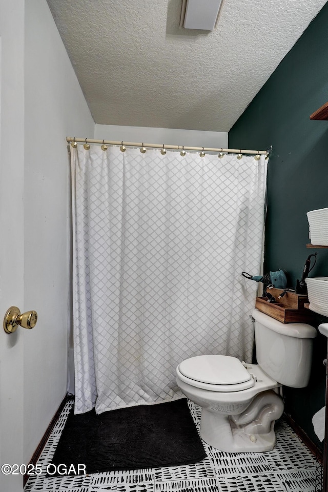 2413 Rolla St, Joplin, MO 64801 - bathroom with toilet, a textured ceiling, and a shower with curtain