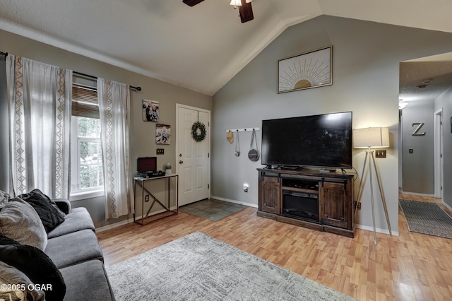 2413 Rolla St, Joplin, MO 64801 - living area with light wood-type flooring, ceiling fan, vaulted ceiling, and baseboards