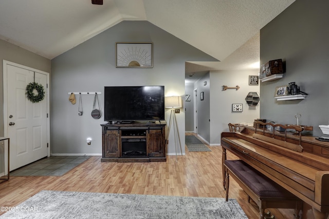 2413 Rolla St, Joplin, MO 64801 - living area featuring light wood finished floors, vaulted ceiling, baseboards, and a ceiling fan