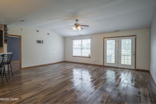 522 E Yale St, Liberal, MO 64762 - unfurnished living room featuring vaulted ceiling, wood finished floors, a ceiling fan, and baseboards
