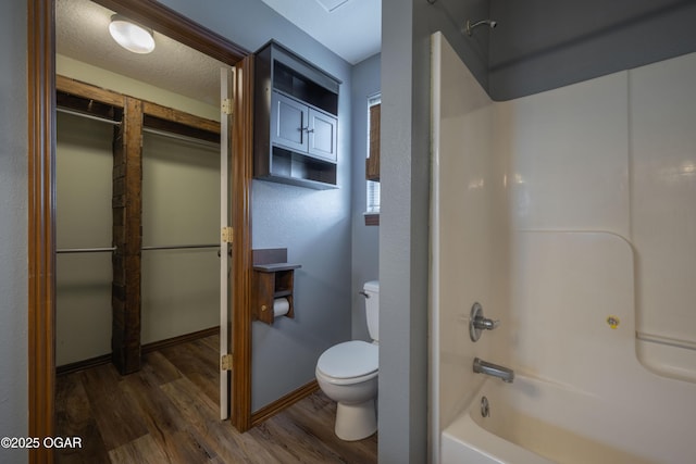 522 E Yale St, Liberal, MO 64762 - bathroom with toilet, wood finished floors, and shower / bath combination