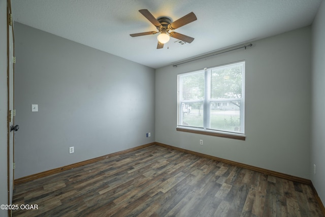 522 E Yale St, Liberal, MO 64762 - unfurnished room with wood finished floors, a ceiling fan, and baseboards