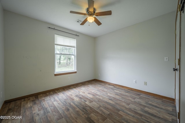 522 E Yale St, Liberal, MO 64762 - empty room featuring wood finished floors, ceiling fan, and baseboards