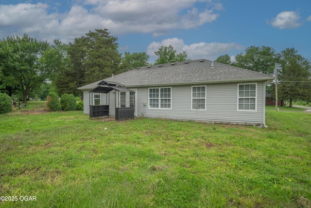 522 E Yale St, Liberal, MO 64762 - back of property with a lawn, a shingled roof, and cooling unit