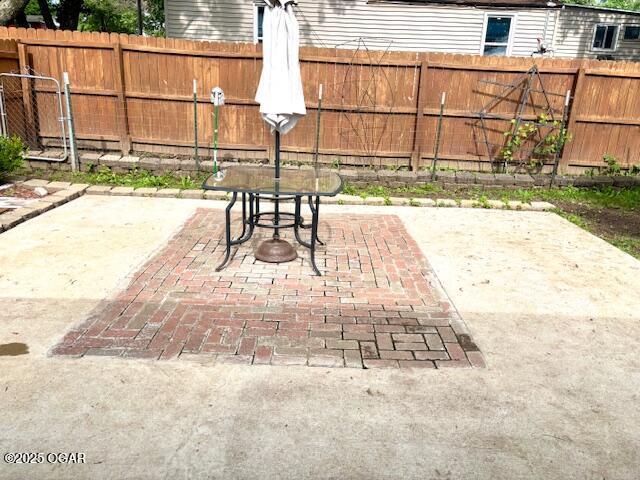 1300 S Baker Blvd, Carthage, MO 64836 - fenced backyard with a patio and outdoor dining space