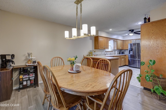 1241 Douglas Ct, Carthage, MO 64836 - dining room with light wood-style floors, ceiling fan, recessed lighting, and a textured ceiling