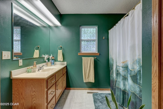 1241 Douglas Ct, Carthage, MO 64836 - bathroom featuring vanity, a textured ceiling, tile patterned flooring, a shower with shower curtain, and baseboards