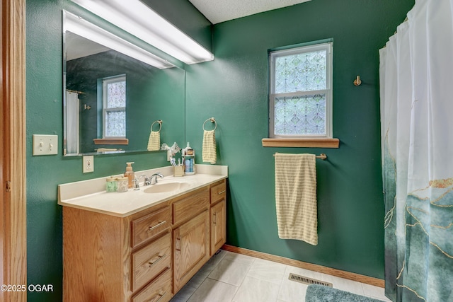 1241 Douglas Ct, Carthage, MO 64836 - bathroom with vanity, healthy amount of natural light, baseboards, and tile patterned flooring