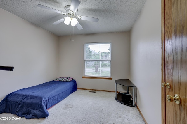 1241 Douglas Ct, Carthage, MO 64836 - carpeted bedroom featuring a textured ceiling, baseboards, and a ceiling fan