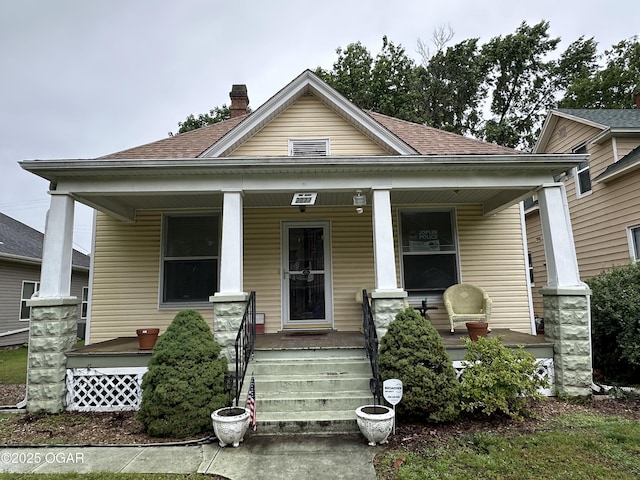 2022 S Jackson Ave, Joplin, MO 64804 - view of front of home featuring covered porch, roof with shingles, and a chimney