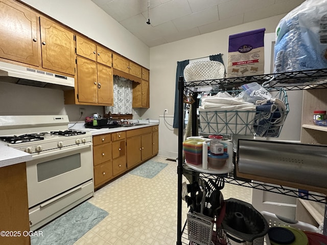 2022 S Jackson Ave, Joplin, MO 64804 - kitchen with white range with gas stovetop, extractor fan, light countertops, and light flooring