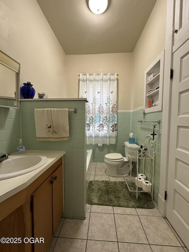 2022 S Jackson Ave, Joplin, MO 64804 - bathroom featuring tile walls, tile patterned floors, a wainscoted wall, vanity, and toilet