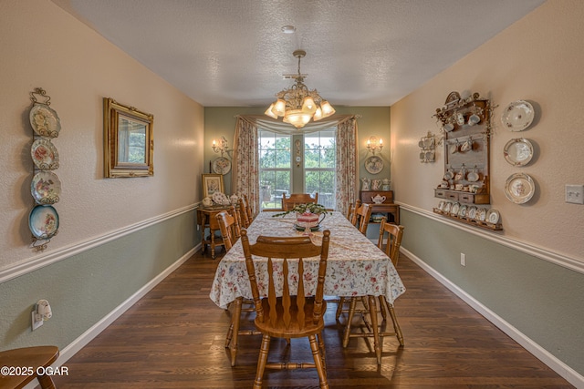 4430 E 26th St, Joplin, MO 64804 - dining space with a chandelier, dark wood-style flooring, a textured ceiling, a textured wall, and baseboards