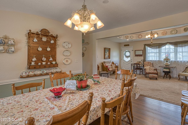 4430 E 26th St, Joplin, MO 64804 - dining area featuring a chandelier, wood finished floors, and a textured ceiling