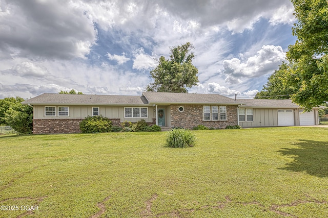 4430 E 26th St, Joplin, MO 64804 - ranch-style house with board and batten siding, a front lawn, and an attached garage