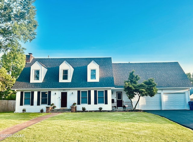 1910 Carolina Ave, Joplin, MO 64801 - view of front of home with asphalt driveway, a chimney, a garage, and a shingled roof