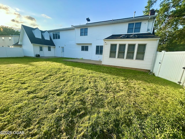 1910 Carolina Ave, Joplin, MO 64801 - rear view of house with a chimney, a patio area, and a gate