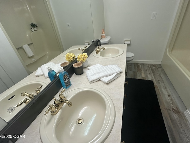 1910 Carolina Ave, Joplin, MO 64801 - bathroom featuring double vanity, toilet, and wood finished floors