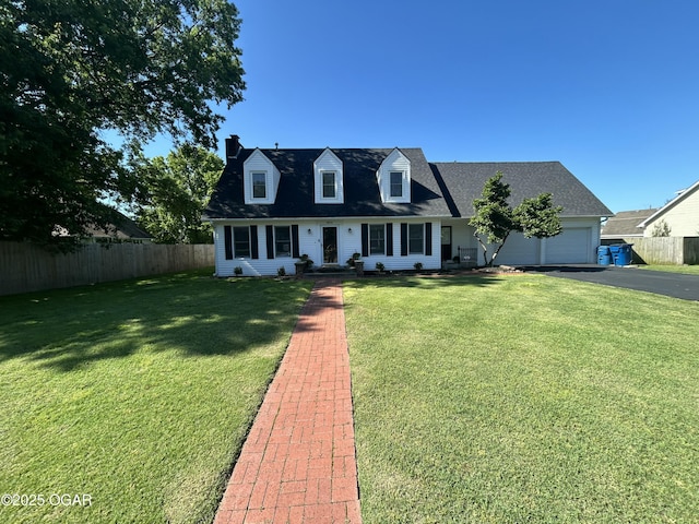 1910 Carolina Ave, Joplin, MO 64801 - cape cod-style house with asphalt driveway, a chimney, an attached garage, and roof with shingles