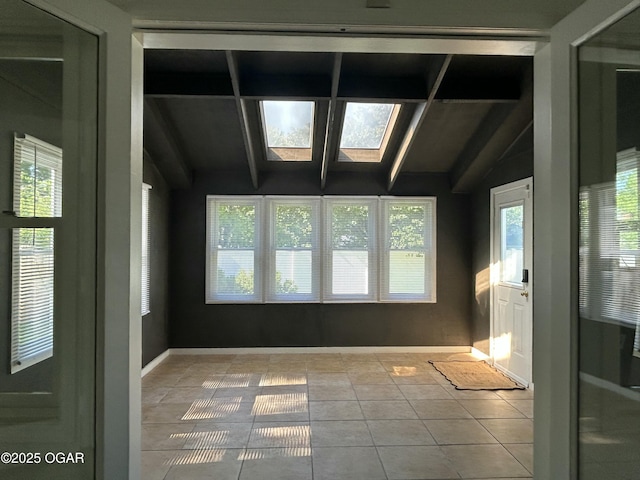 1910 Carolina Ave, Joplin, MO 64801 - spare room featuring tile patterned flooring, a skylight, and plenty of natural light