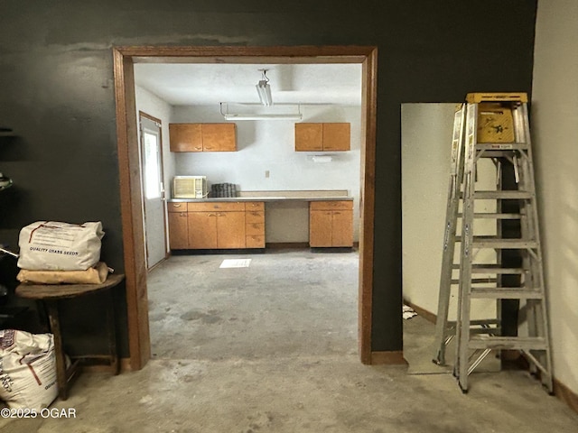 1910 Carolina Ave, Joplin, MO 64801 - kitchen with unfinished concrete flooring and brown cabinetry