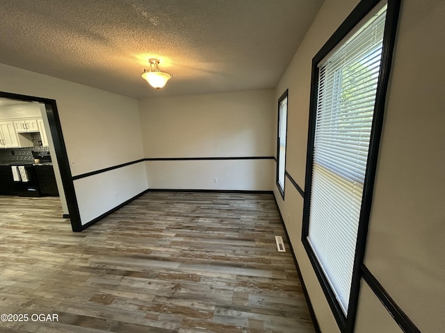 1910 Carolina Ave, Joplin, MO 64801 - unfurnished room featuring wood finished floors and a textured ceiling