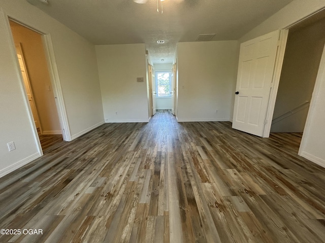 1910 Carolina Ave, Joplin, MO 64801 - spare room featuring dark wood-style floors and baseboards