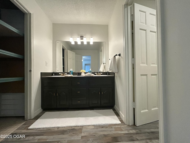 1910 Carolina Ave, Joplin, MO 64801 - full bath featuring double vanity, wood finished floors, a textured ceiling, and baseboards