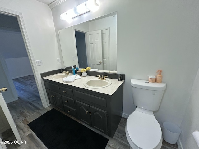 1910 Carolina Ave, Joplin, MO 64801 - bathroom with wood finished floors, double vanity, toilet, and baseboards
