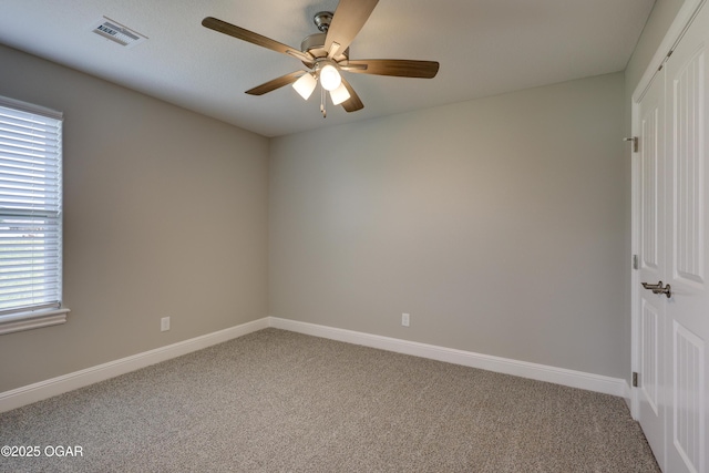 1919 Wisconsin Ave, Joplin, MO 64804 - carpeted empty room with a ceiling fan and healthy amount of natural light