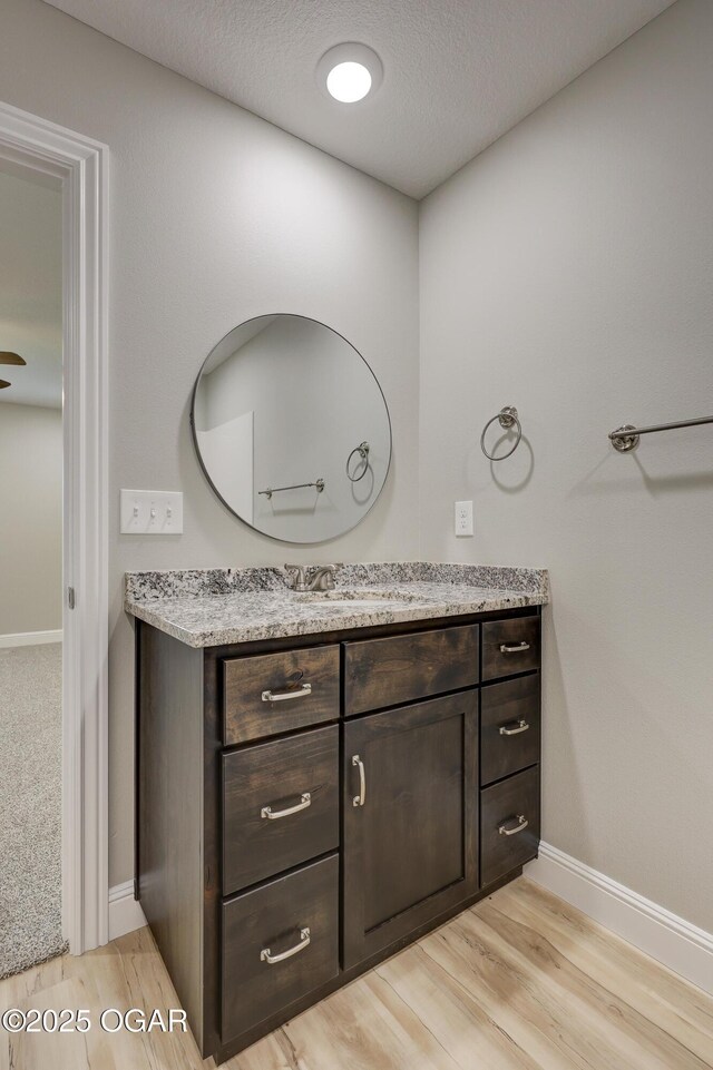 1919 Wisconsin Ave, Joplin, MO 64804 - bathroom featuring vanity, wood finished floors, and a textured ceiling