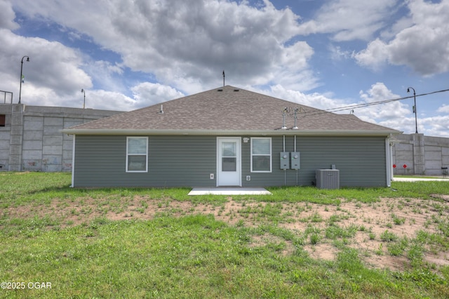 1919 Wisconsin Ave, Joplin, MO 64804 - rear view of property featuring roof with shingles, a yard, and a patio area