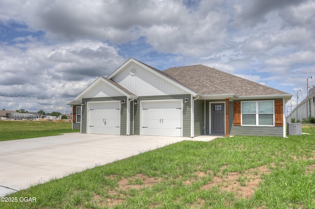 1919 Wisconsin Ave, Joplin, MO 64804 - view of front of house featuring an attached garage, driveway, a front yard, and roof with shingles