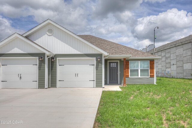 1919 Wisconsin Ave, Joplin, MO 64804 - view of front of property with a garage, concrete driveway, a front lawn, and roof with shingles