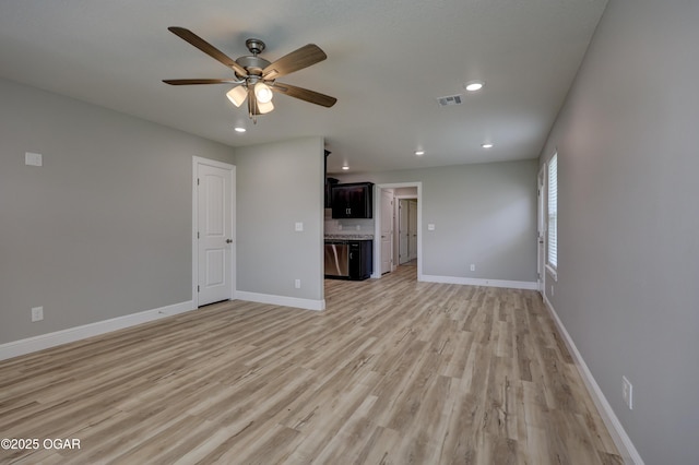 1919 Wisconsin Ave, Joplin, MO 64804 - unfurnished living room with light wood-style flooring, a ceiling fan, and recessed lighting